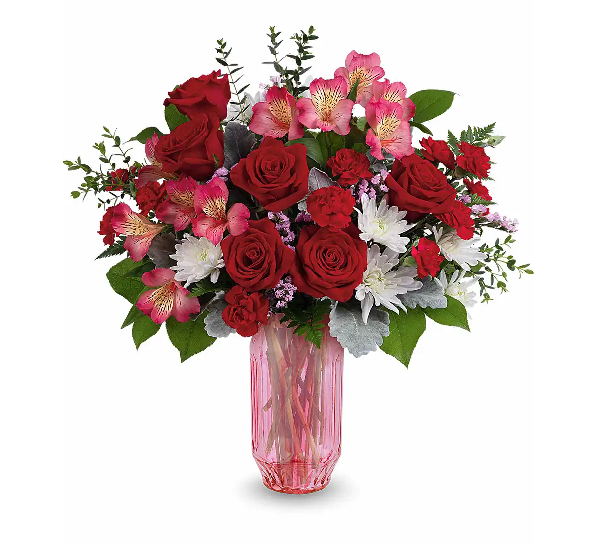 Red and pink Valentine’s Day bouquet with roses and mixed blooms in a faceted pink glass vase.