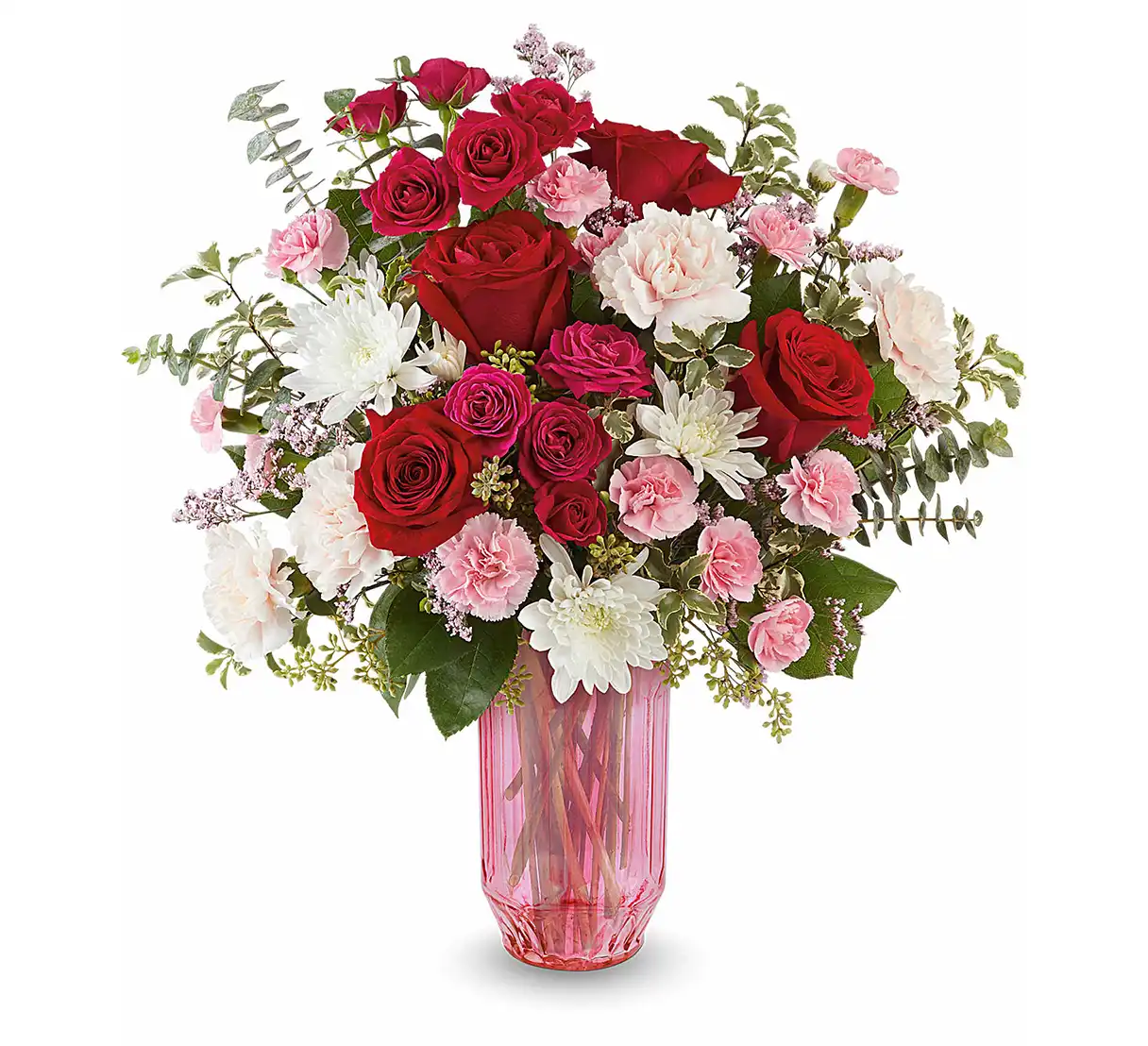 Red and pink flower bouquet with roses and carnations in a faceted pink glass vase.