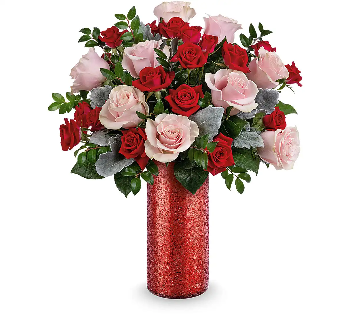Pink roses and red spray roses arranged with greenery in a red glass vase.
