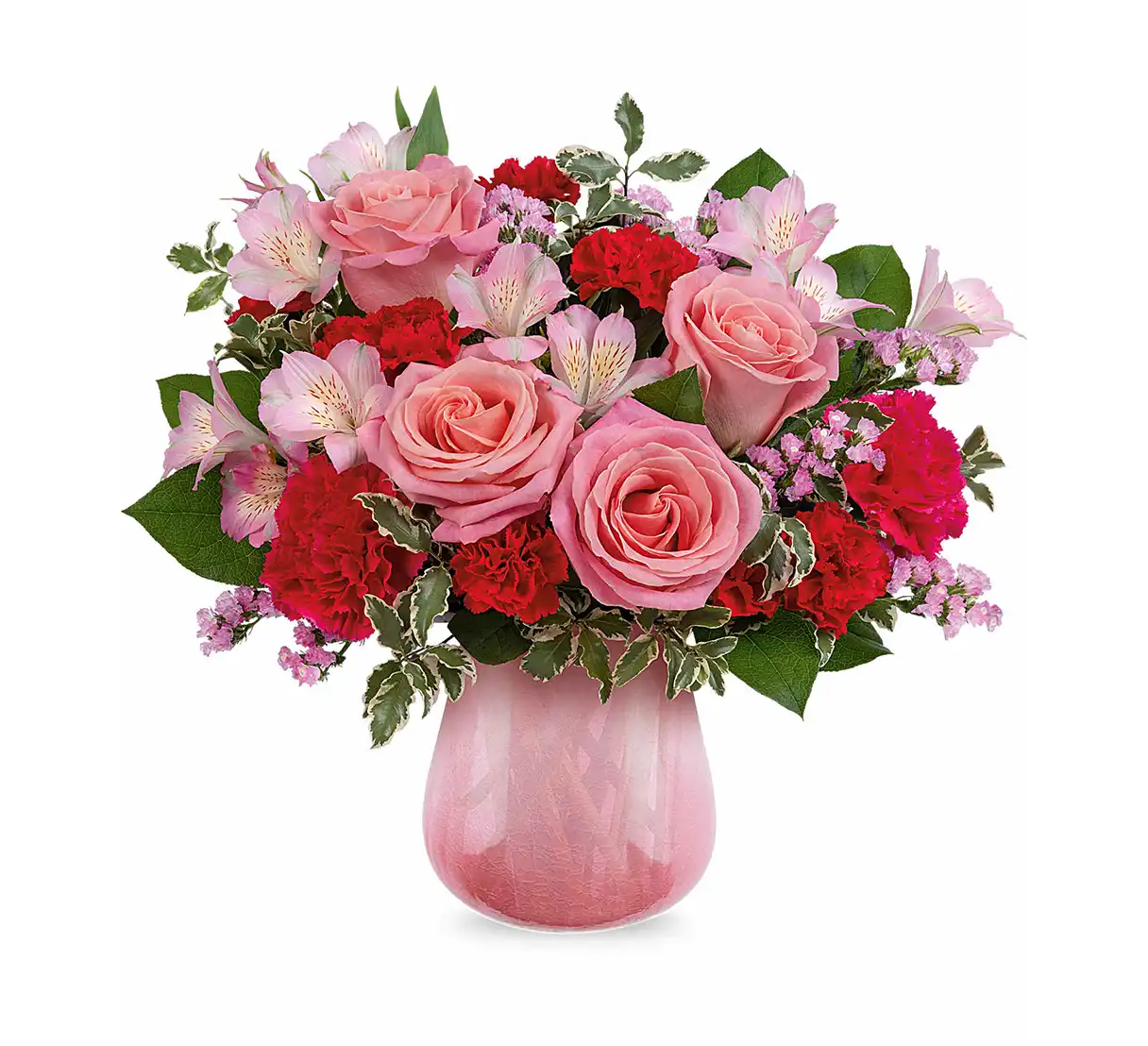 Pink rose and carnation bouquet with mixed pink blooms in a translucent pink glass vase.